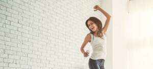 YOUNG WOMAN JUMPS FOR JOY