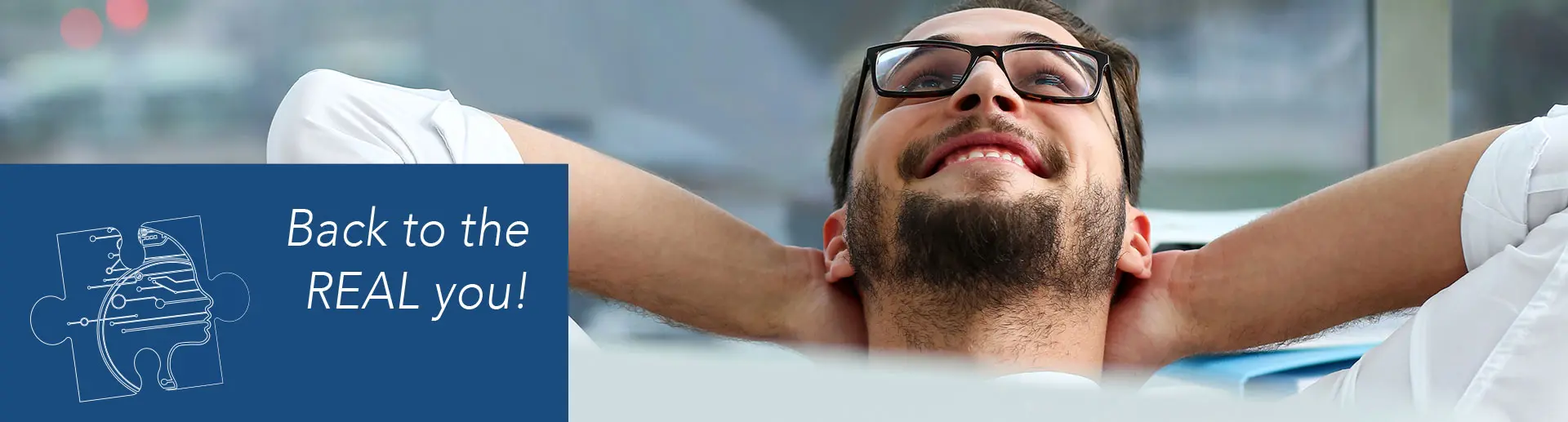 MAN RELAXING WITH HEAD BACK ON HANDS, SMILING